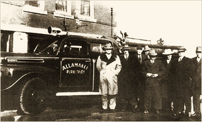 Historic photograph of the Allamakee rural fire truck and local men